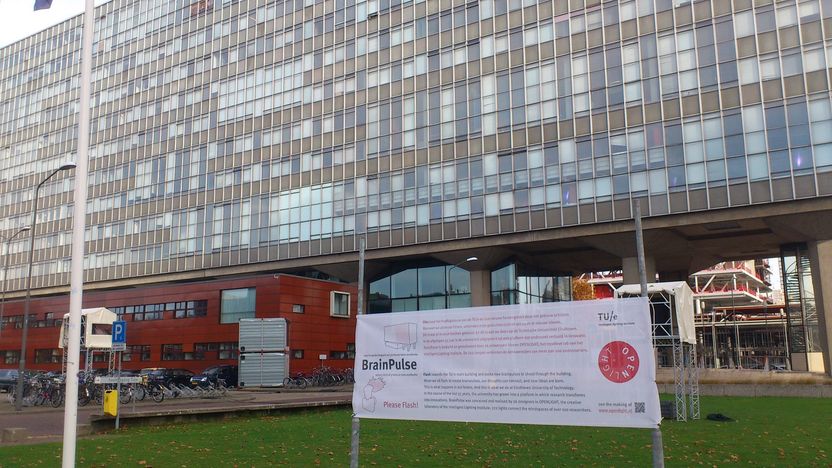 The university building where this experiment takes place, with a standing post sign in front of the building